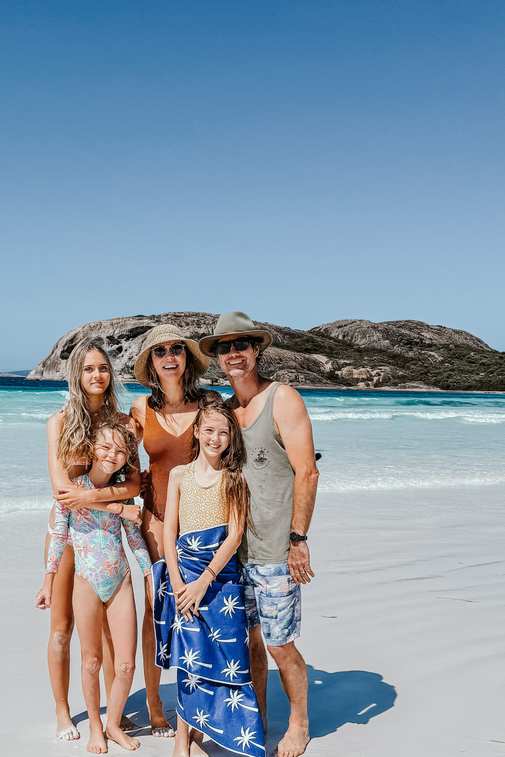 Family of five standing together on the beach, preparing for full-time travel – Journey of Five
